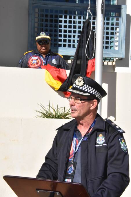 Superintendent Glen Pointing addressed the crowd while Senior Police Liaison Officer Barbara Costello waited to raise the Aboriginal flag.