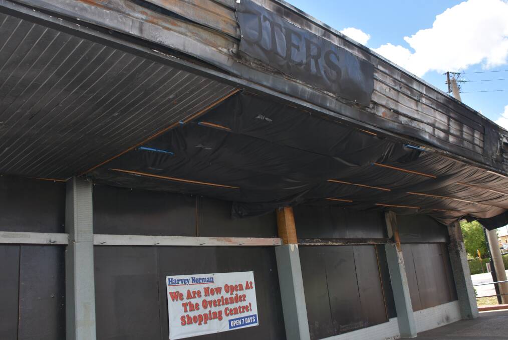 EYESORE:The dilapidated old Harvey Norman building on the corner of Miles St a year on from the fire. Photo: Melissa North
