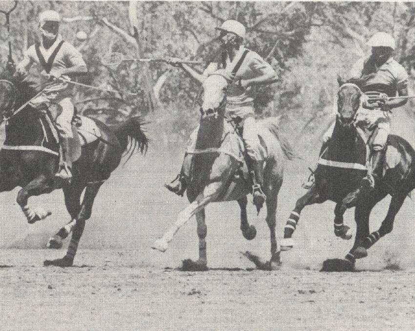 Competition: Bill Donovan, of Mount Isa, Charlie Underwood and Bruce Underwood of Tangorin, battle for possession in action at the Polocrosse at the Games.