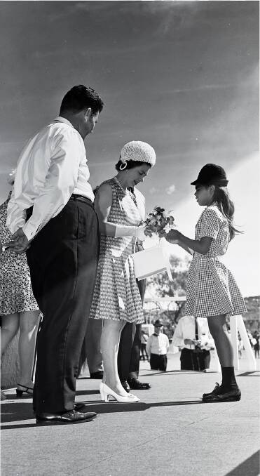 MEETING LOCALS: Queen Elizabeth accepts flowers from Bernadette Dargan during her visit to Mount Isa in 1970. 