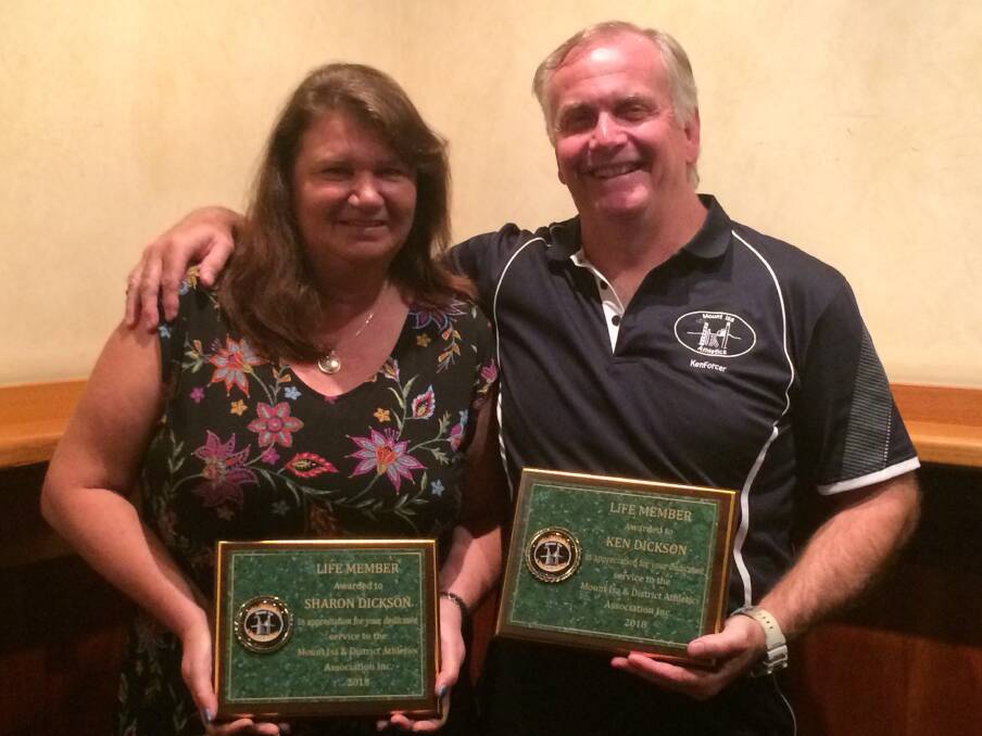 LIFE MEMBERS: Sharon and Ken Dickson receive their lifetime members awards from the Mount Isa Athletics Club.