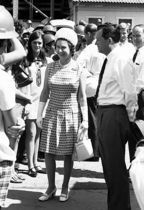 MINE VISIT: Queen Elizabeth and Mount Isa Mines general manager James Foots during a walk through with Mount Isa Mines employees in 1970. 