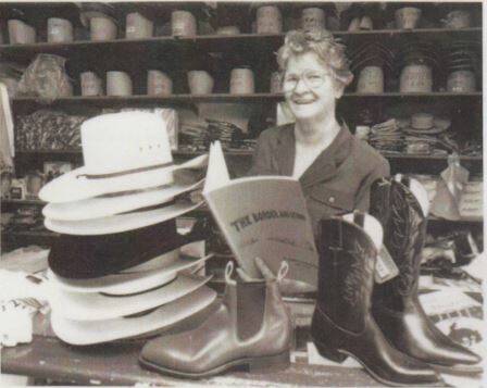 BORDER AND BEYOND: Ada Miller reading her book the Border and Beyond behind the counter of Freckleton's Store, Camooweal in 1984.