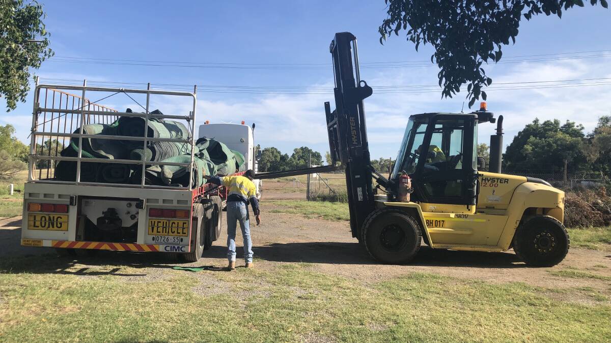 THANKS: WWATS and Barkly Hire helped transport and move the turf from Townsville to Mount Isa. Photos supplied.