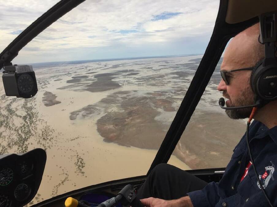 Simon Steele flying over flood waters near Julia Creek after the monsoonal flood of 2019. Photo supplied.