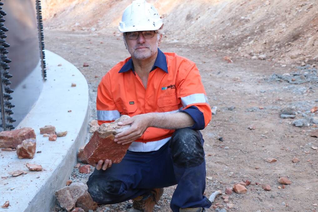 Site foreman Ben Blomkamp with one of the rocks thrown at the Pamela Street Hill reservoir.