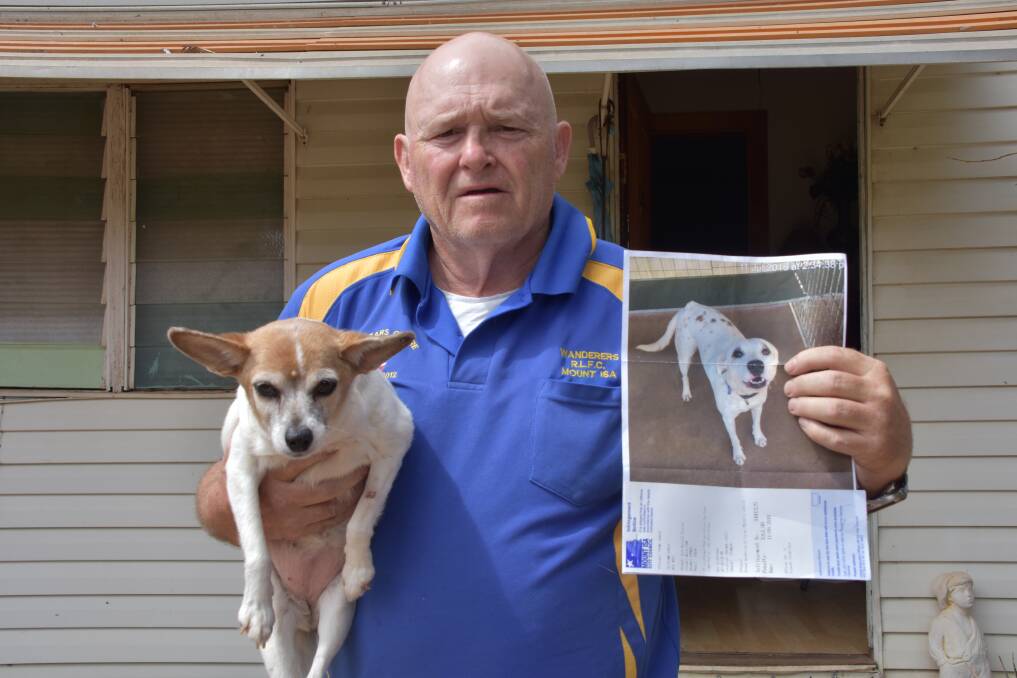 Mr Shuker shows the photo Council sent him compared to his dog.
