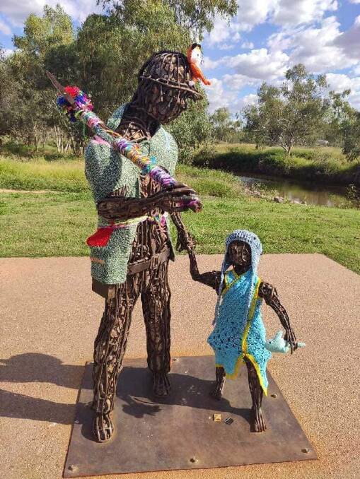 Miner and child statue has been yarn bombed at Isa Street Bridge. Photo supplied.