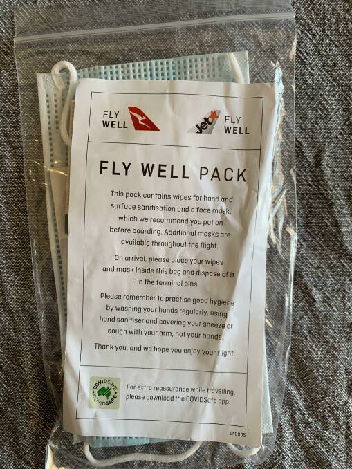 The Fly Well pack is available for all passengers before boarding a Qantas flight and includes a face mask and sanitising wipes. Photo: Samantha Campbell.
