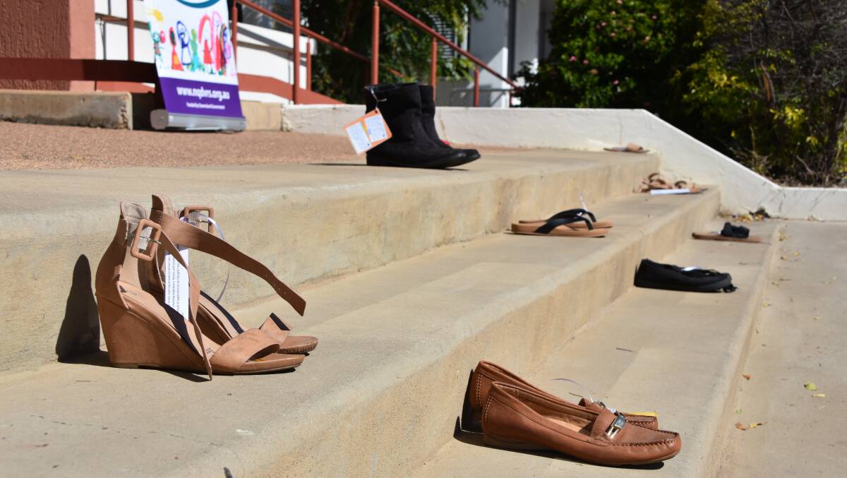 Shoes line the steps of NQDVRS in Mount Isa to represent women and children survivors of domestic and family violence. Photo: Samantha Campbell.