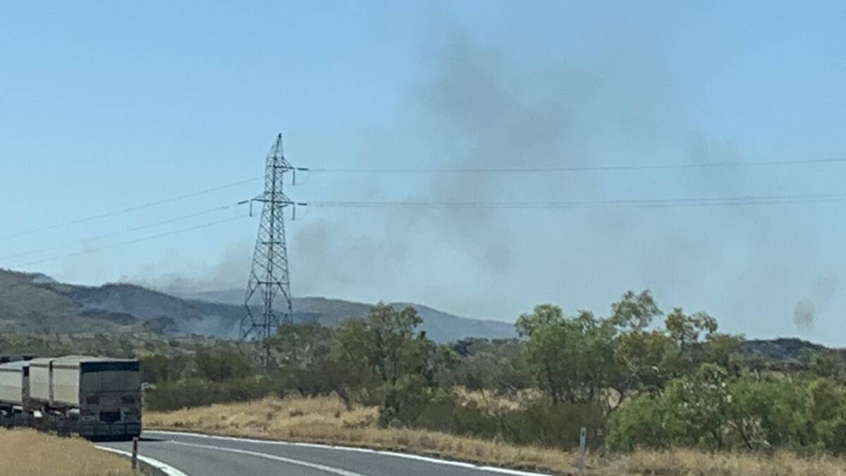 The fire was slowly burning through bush land on Saturday morning, but has since reached the highway. Photo: Samantha Campbell.