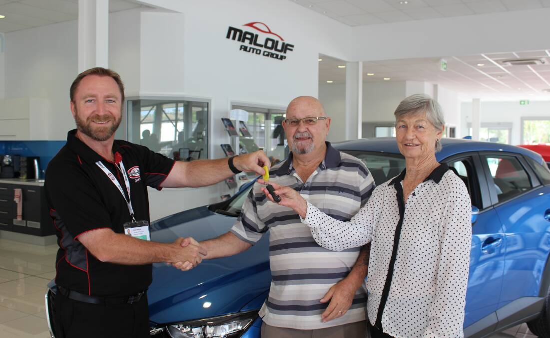 Paul Malouf hands over the keys of the Mazda CX-3 Neo to lucky winners Ron and Eleanor Stickland.