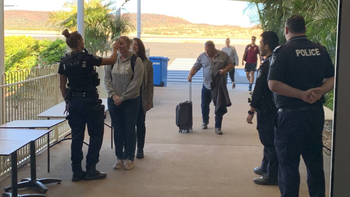 CHECKING: Queensland Police temperature test passengers as they land in Mount Isa. Photo: Samantha Campbell.