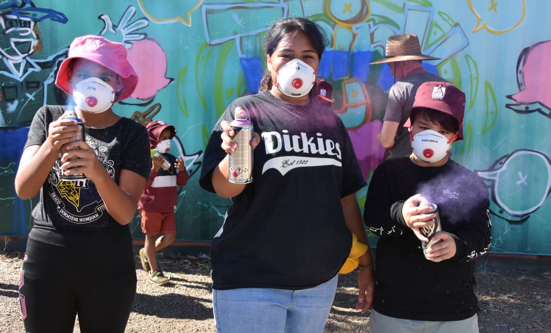 STREET ART: Mia Rankine, Nika Sala and Tasianna Siallo test out their new graffiti art skills at PCYC. Photo: Samantha Campbell.