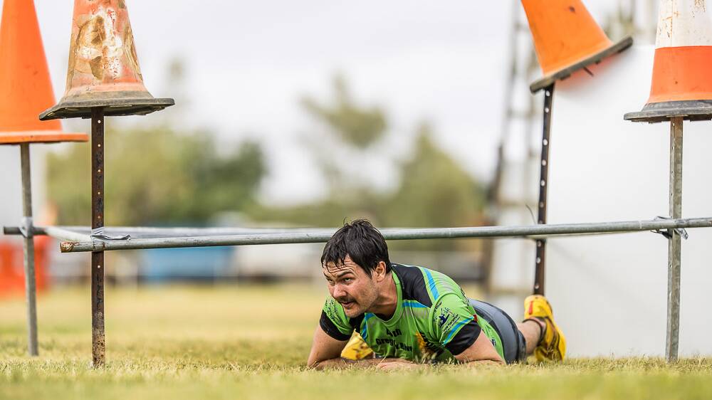 Toby Wicks gets low, taking on the adventure run obstacles. Photos: Jo Thieme Photography
