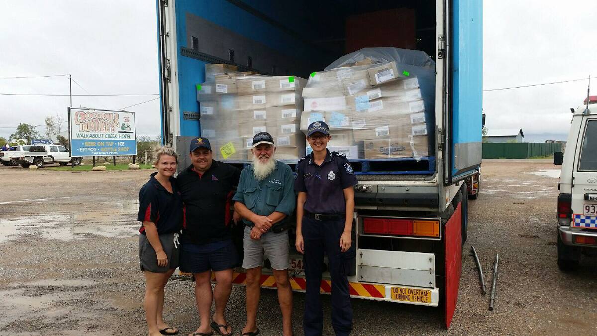 Residents unpack a Woolworths truck full of donated meat. Photo supplied.