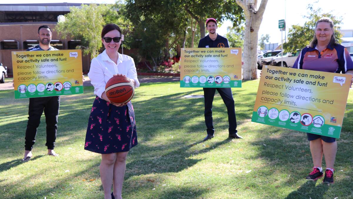 Pictured from left, Mount Isa Basketball Association President Jerome Sopoaga,Councillor Peta MacRae, Mount Isa Rugby Union Secretary Jason Newell and Mount Isa Netball Association Treasurer Barbara Baker with the signs.