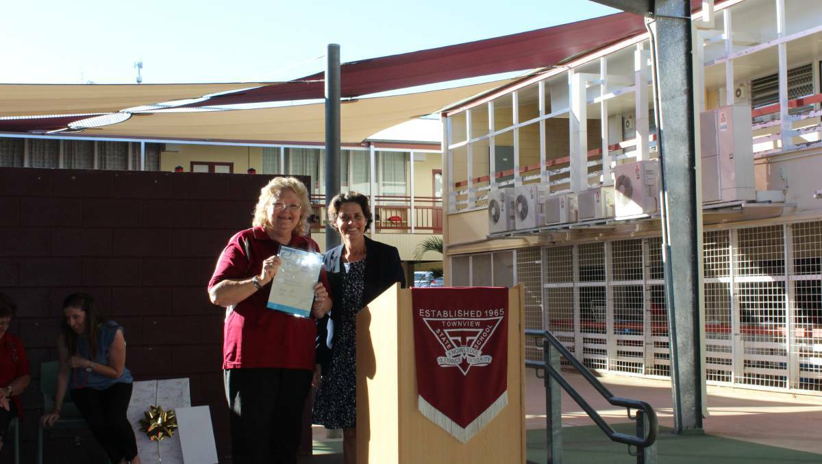 ACHIEVEMENT: Evelyn Arnold is presented with her Certificate of Recognition from Townview principal Alana Scott in 2017 for 40 years service. Photo: supplied.
