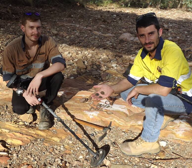 Dan Kropp and Sam Verlaano search Mount Isa riverbed for hidden treasures, featured with old coins, horseshoes, belt buckles and a 1916 dog collar. Photo supplied.