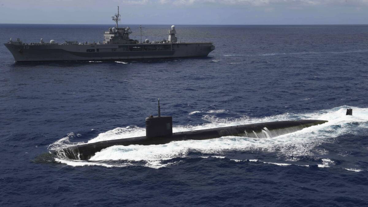 The fast-attack submarine USS Asheville transits alongside the USS Blue Ridge in the Philippine Sea. Picture: US Department of Defense