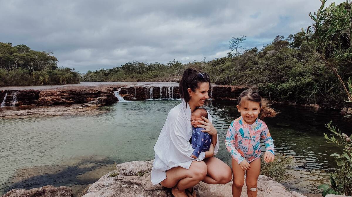Stacey Finch with her children Harry, four weeks old at the time and Chloe, 3, at Fruit Bat Falls, north of Weipa. Mrs Finch flew to Brisbane to give birth to Harry.