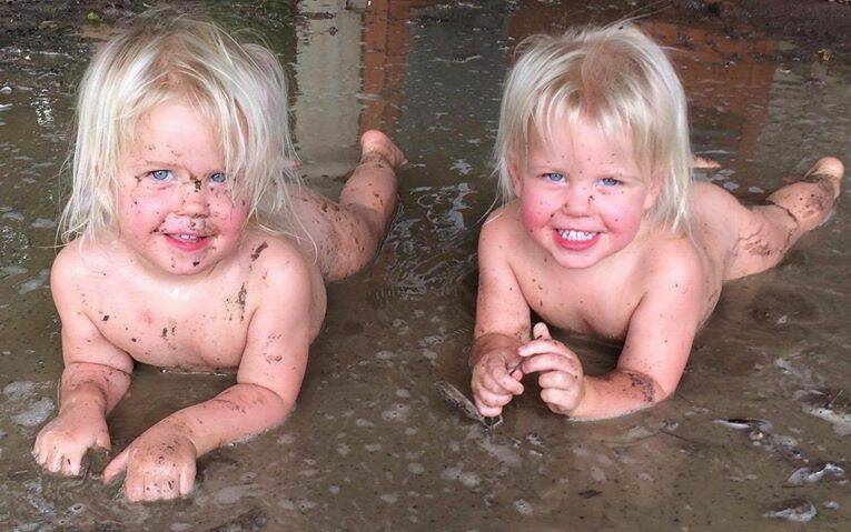 Twins Skyla and Hayley Ievers, Gregory Range Station, Richmond enjoying the mud after the recent rain.