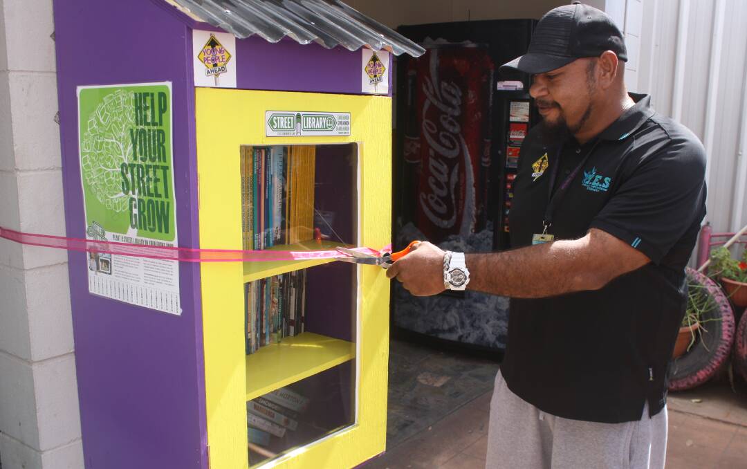OPEN-BOOK: Evan Ah Wing cutting the ribbon to unveil the street library at Young People Ahead, Mount Isa. Photo: Aidan Green 
