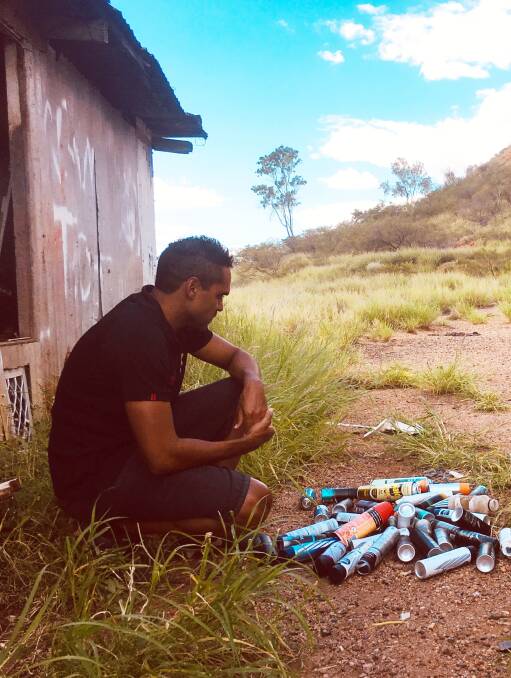 Christopher Rankine in the community collecting VSM paraphernalia an in abandoned allotment in Mount Isa.