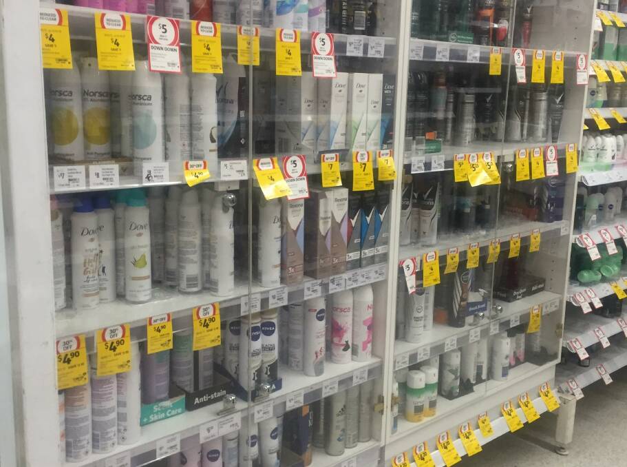 LOCKED-UP: Aerosol cans in Mount Isa coles locked away to deter chroming. Photo: Aidan Green. 