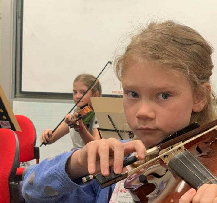 Mount Isa School of the Air's Hayley Woodhouse plays her violin at the State Honours Ensemble Program.