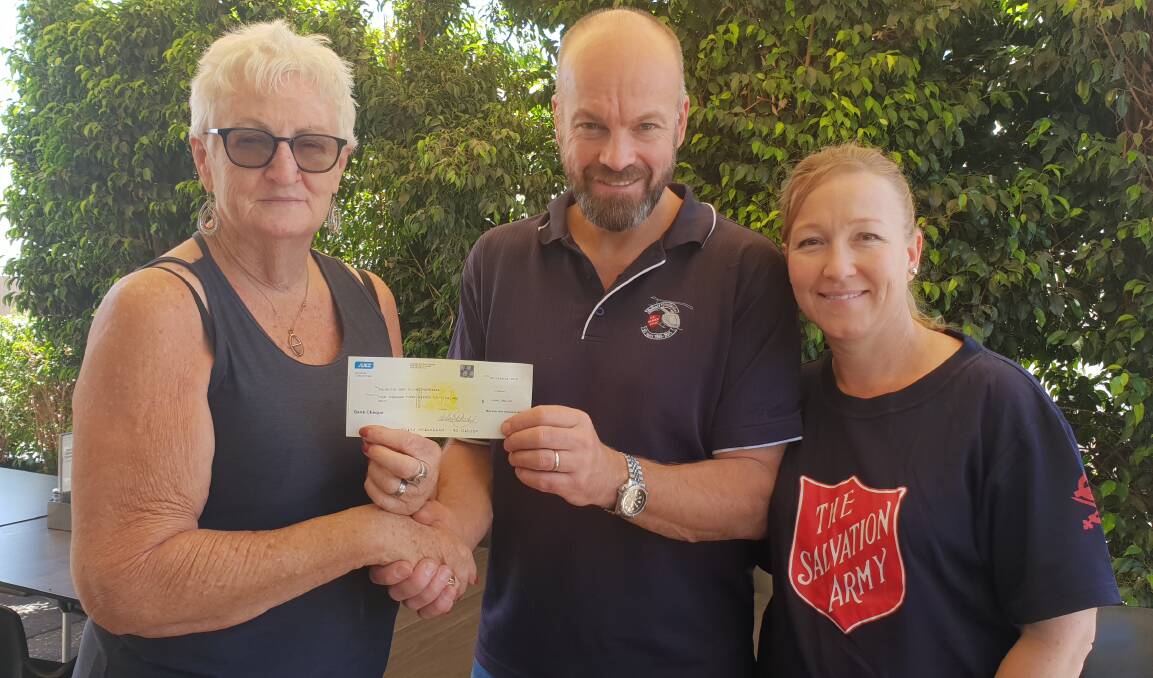 Pam Forster handing over a cheque for $4,800 to Simon and Natalie Steele of the Salvation Army Flying Padre. 