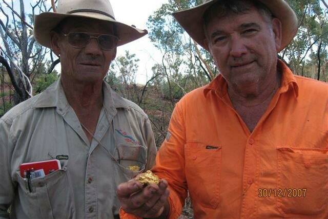 GOLD DIGGING: Tom Donovan and Trevor Stretton (right) with a detected nugget at Golden Sunset in 2007. Photo supplied. 