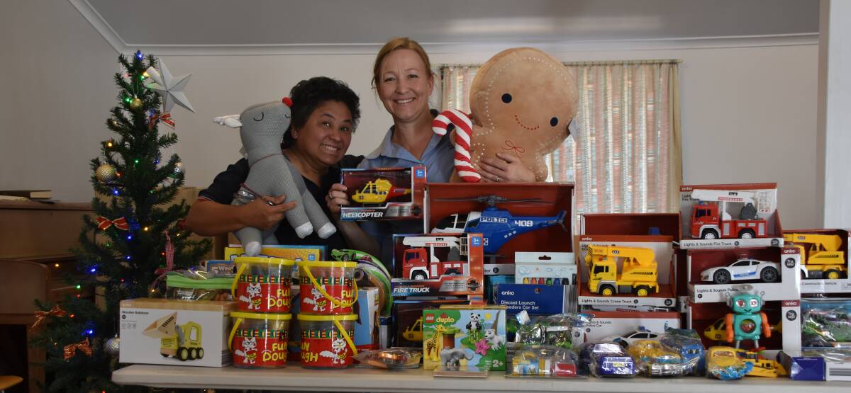GIFT OF GIVING: May Batts and Natalie Steele showing off some of the toys ready for donation. Photo: Aidan Green 