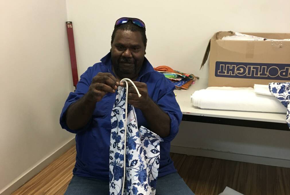 RUGGED UP: A Mount Isa Work for the dole participant knits a blanket. 
