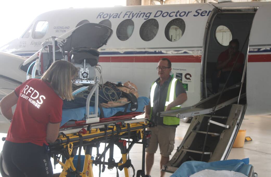 The RFDS holds a demonstration of putting a paitent on the plane. Photo: Aidan Green