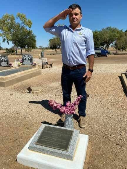 Winton Mayor Gavin Baskett salutes at the grave of Matt Quinlan recently after learning of his heroics. 