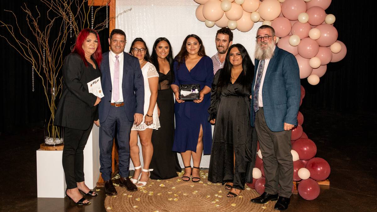 Top honours: Lee Potini (left) and her Blackwoods team members accept the Business of the Year award from Jemena's Craig Farrugia. Picture: Supplied. 