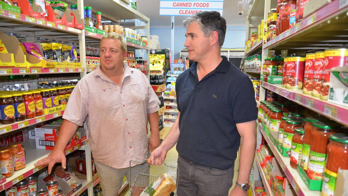 Bob Burow, pictured chatting with then Member for Mount Isa Rob Katter at his shop Colonial Convenience previously, has had about 70% of bread products pulled from his shelves by Goodman Fielder. 