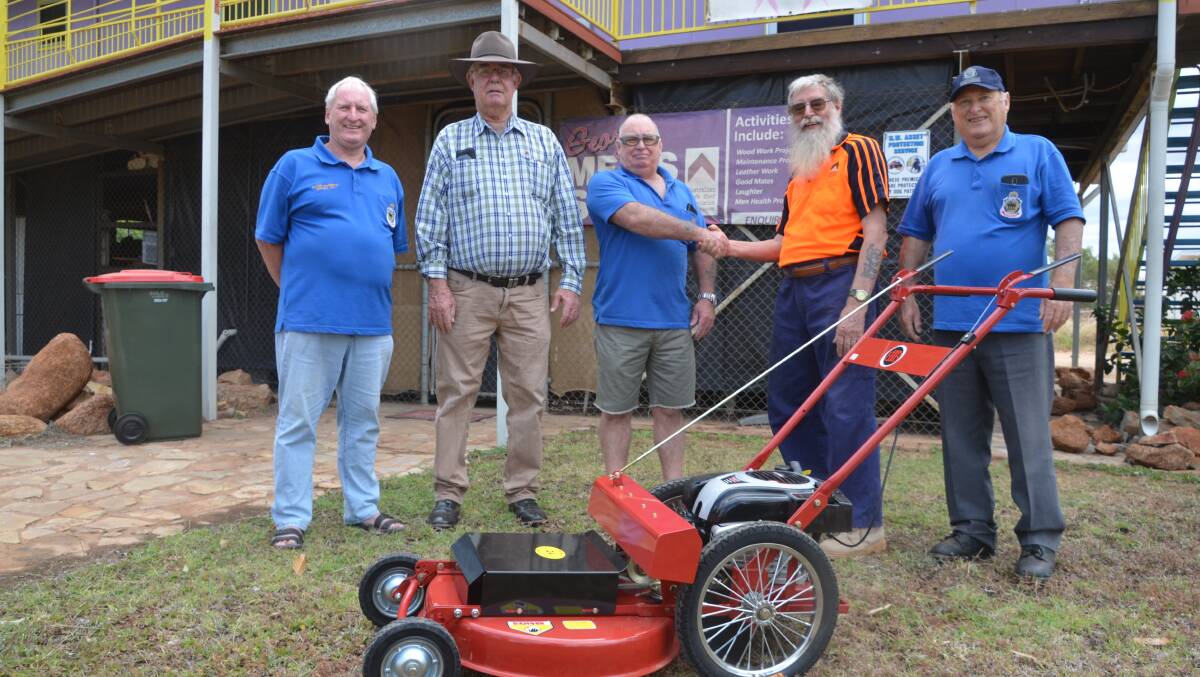 HELPING HAND: RSL's Peter Roberts, Bob Burdon, Tony Smith and Steve Wollaston hand the new mower over to the Menshed's Richard Lane.Photo: Derek Barry