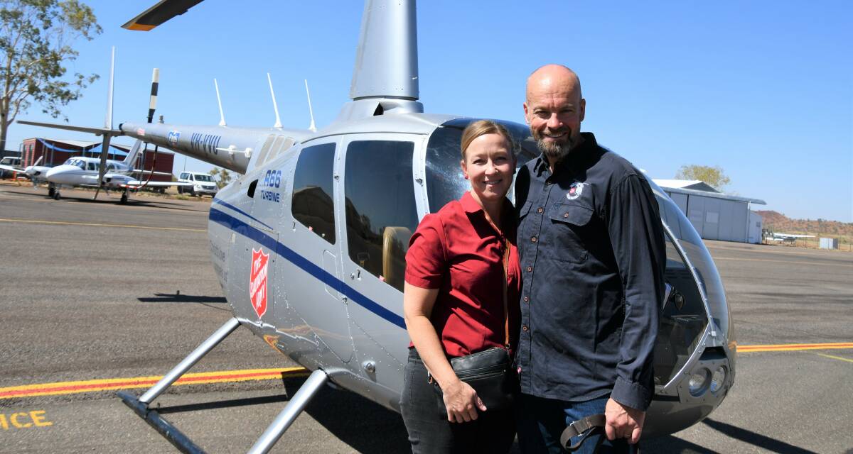 The Flying Padres Natalie and Simon Steele at Mount Isa Airport with their helicopter.