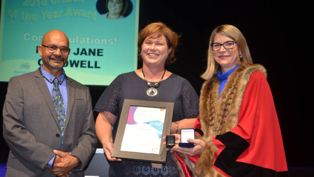 Mary-Jane Caldwell accepts the 2018 Mount Isa citizen of the year from deputy mayor Phil Barwick and mayor Joyce McCulloch.