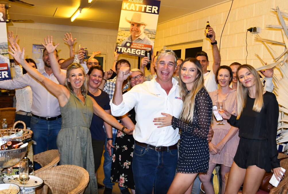 Robbie Katter celebrates victory with wife Daisy and supporters on Saturday night.