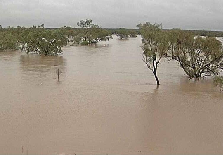 One of Boulia Shire Council's cameras catches water from the Diamantina River over a road in the shire on Thursday morning.