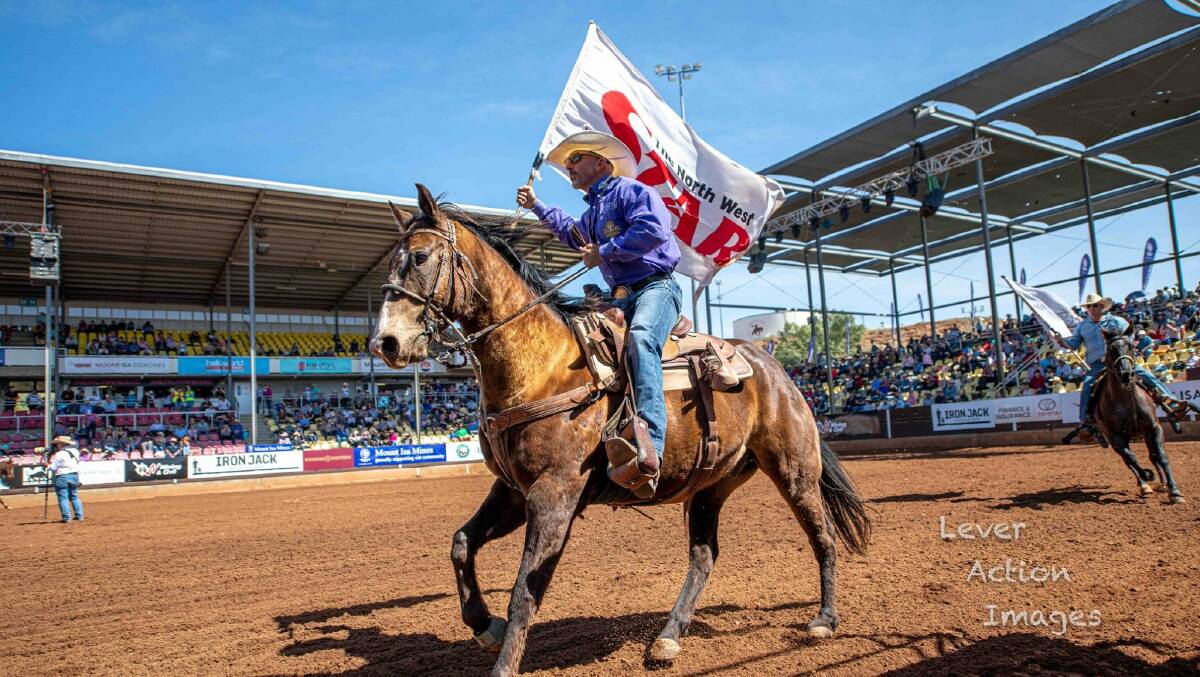 Kerry Brisbane took this great photo of the North West Star sponsor flag being carried around the arena during the Mount Isa Mines Rodeo.