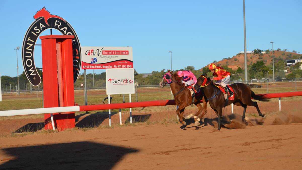 NECK AND NECK FINISH: Anymore on the rails holds off Split the Atom to win the Mount Isa Cup by a neck.Photo: Derek Barry