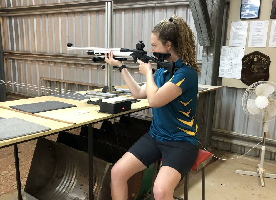 Shannae Grant in action with the new specialised stand at Mount Isa Pistol Club.
