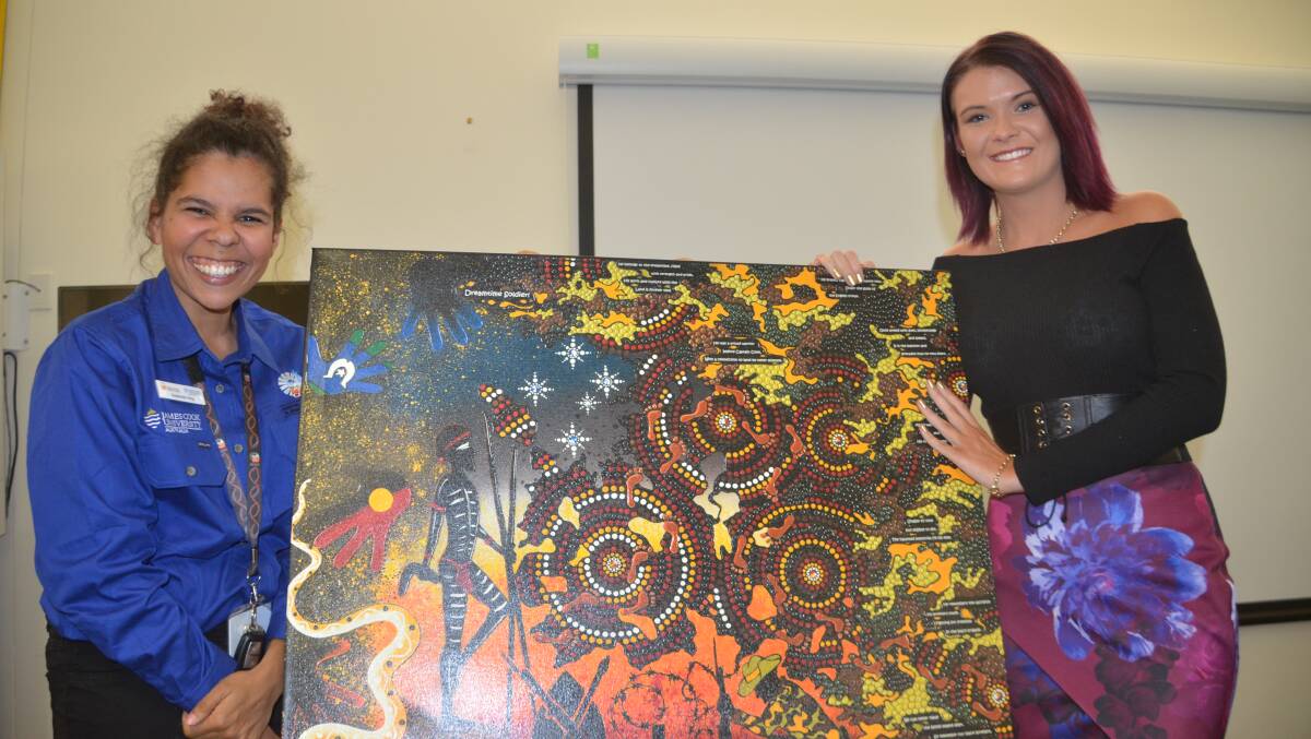 Steph King and Chern'ee Sutton with the artist's painting Dreamtime Soldier (2014).
