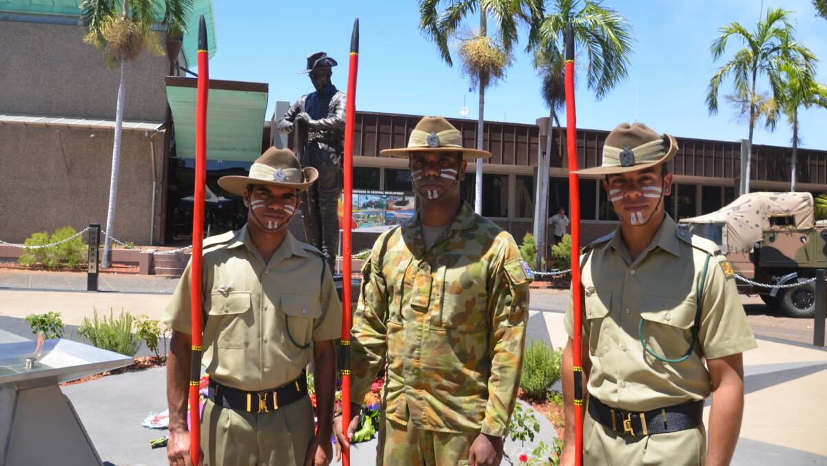 Privates Raymond Dalton, Jordan Tamate and Carl Casey with their spears at the Mount Isa Cenotaph on Remembrance Day.