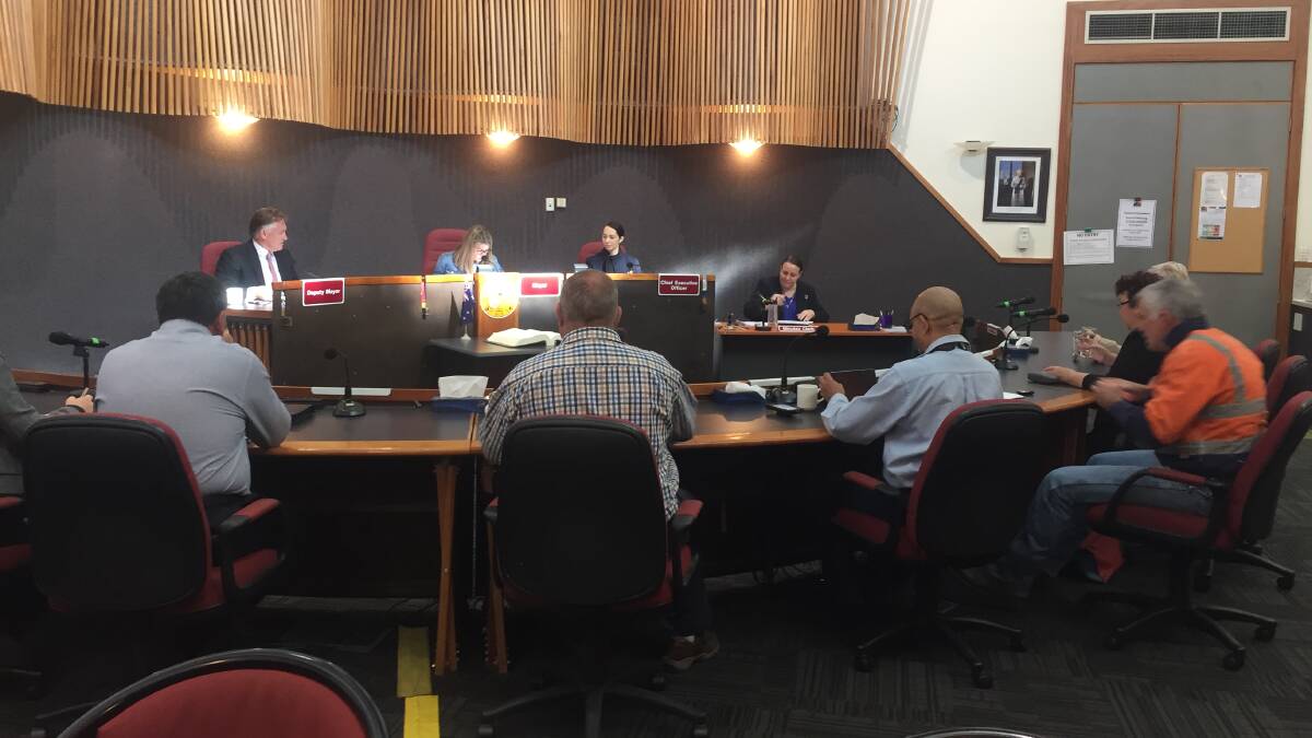 Mount Isa Mayor Joyce McCulloch hands down the budget in chambers on Friday.