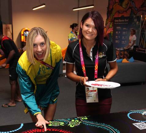 Kalkadoon artist Chern’ee Sutton (right) began work on the 12 metre painting at the Gold Coast Commonwealth Games